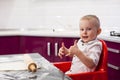 Little boy preparing dough. Boy kneads dough in the kitchen Royalty Free Stock Photo