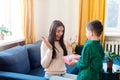 Little boy presenting gift to happy mother on Mothers Day Royalty Free Stock Photo