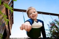 Little Boy Pretends To Fly On Swingset