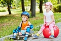 Little boy in protective equipment sits on Royalty Free Stock Photo