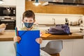 Little boy with a protective mask and school supplies at home ready for school. Horizontal