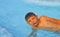 Little boy in the public swimming pool. Portrait of little boy in the swimming pool. Sunny summer day. Summer and happy chilhood c