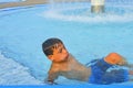 Little boy in the public swimming pool. Portrait of little boy in the swimming pool. Sunny summer day. Summer and happy chilhood c