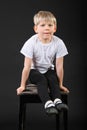 Little boy pull on hands at old stool Royalty Free Stock Photo