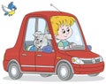 Little boy and pup driving a toy car