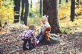 Little boy put shoes on girl feet. Brother help sister to put red boots. Helping hand concept. Children getting ready Royalty Free Stock Photo