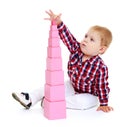 Little boy puts cubes. Royalty Free Stock Photo