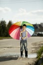 Little boy with a rainbow umbrella in park Royalty Free Stock Photo