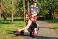 A little boy raises his sister who fell on roller skates. Royalty Free Stock Photo