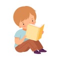 Little Boy Reading Book, Cute Kid Sitting on Floor with Book, Literature Fan, Children Education and Imagination Concept Royalty Free Stock Photo