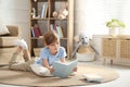 Little boy reading book on floor Royalty Free Stock Photo