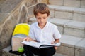 Little boy reading a book on a Stairs Royalty Free Stock Photo