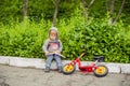 Little boy reading a book under big linden tree Royalty Free Stock Photo