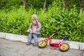 Little boy reading a book under big linden tree Royalty Free Stock Photo