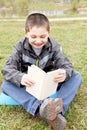 Little boy reading funny book