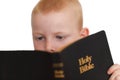 Little boy reading Holy Bible Royalty Free Stock Photo