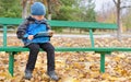 Little boy reading a tablet computer