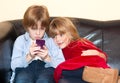 Little boy reading a text message on a smartphone. Royalty Free Stock Photo