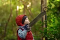 Little boy reads an explanatory sign in the zoo or Park of Nature