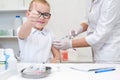 Little boy receiving a vaccination at the clinic against the covid 19 coronavirus, close up Royalty Free Stock Photo