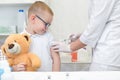 Little boy receiving vaccination at the clinic, close up Royalty Free Stock Photo