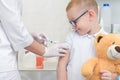 Little boy receiving vaccination at the clinic, close up Royalty Free Stock Photo