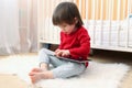 Little boy in red shirt with tablet computer Royalty Free Stock Photo