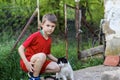 Portrait of boy and cat on balcony in the village on sunny spring day