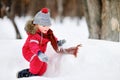 Little boy in red winter clothes having fun with fresh snow Royalty Free Stock Photo