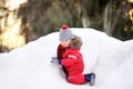 Little boy in red winter clothes having fun with fresh snow Royalty Free Stock Photo