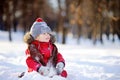 Little boy in red winter clothes having fun with snow Royalty Free Stock Photo