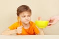 Little boy refuses to eat porridge Royalty Free Stock Photo