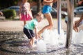 Little boy rejoices at the bubbles and bulbs of the city fountain