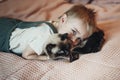 Little boy relaxing on the bed with cat. Child is hugging a cat Royalty Free Stock Photo