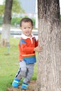 Little boy rely the tree