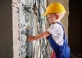 Little boy repairing electrical control panel at home. Royalty Free Stock Photo