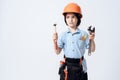 A little boy in repairman form and helmet. Boy holds a adjustable spanner and hammer in his hand. Royalty Free Stock Photo