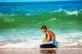 Little boy rest after lesson in the surf school