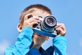 Little boy with retro SLR camera on blue sky Royalty Free Stock Photo