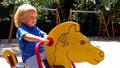 Little boy ridding a toy horse