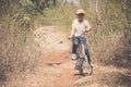 Little boy ride bicycle on the rock road. Royalty Free Stock Photo