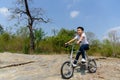 Little boy ride bicycle on the rock road. Royalty Free Stock Photo