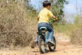 Little boy ride bicycle on the rock road. Royalty Free Stock Photo