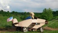 A little boy rides a homemade cardboard plane