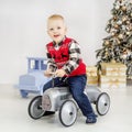 A little boy rides on a toy car. Concept Happy Christmas, New Ye Royalty Free Stock Photo