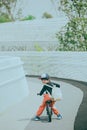 The little boy riding a bicycle is looking back mischievously Royalty Free Stock Photo