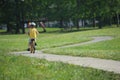 Little boy riding his bicycle on a twisting narrow road