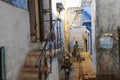 Little boy riding his donkey in narrow alley of jodhpur