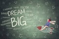 Little boy riding a rocket toward dream big text Royalty Free Stock Photo