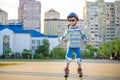 Little boy riding on rollers in the summer in the Park. Happy child in helmet learning to skate Royalty Free Stock Photo